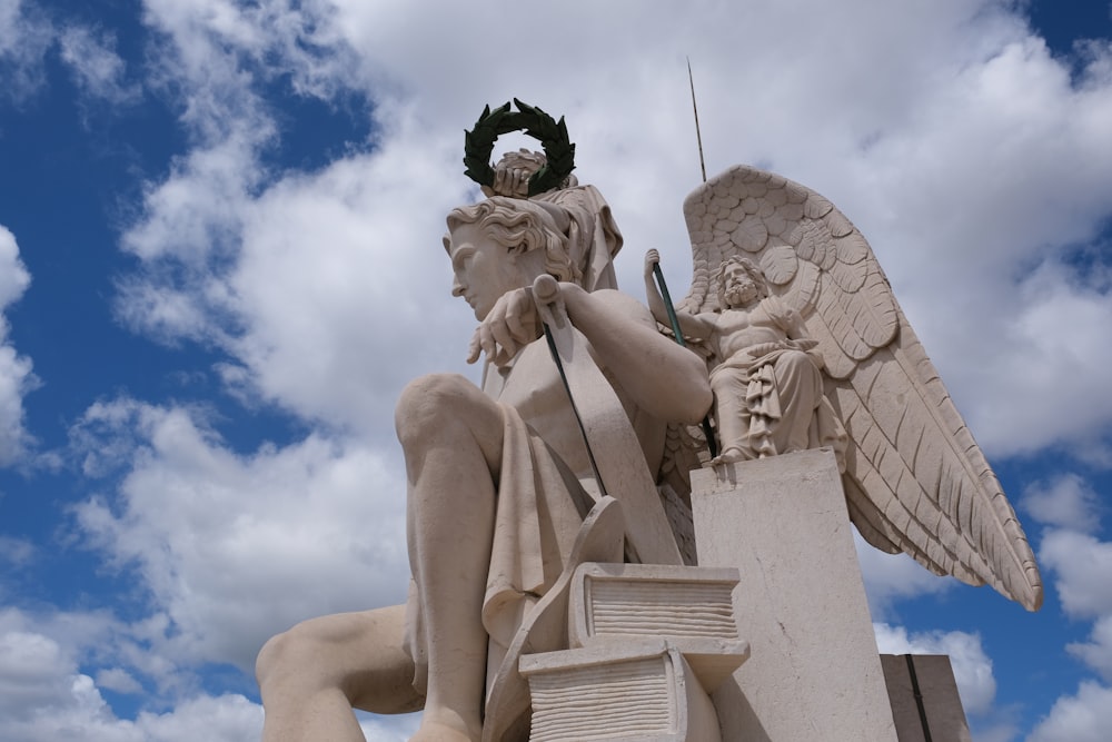 a statue of an angel with a wreath on top of it