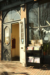 A storefront proudly displaying the zudio franchise logo on a sunny day.