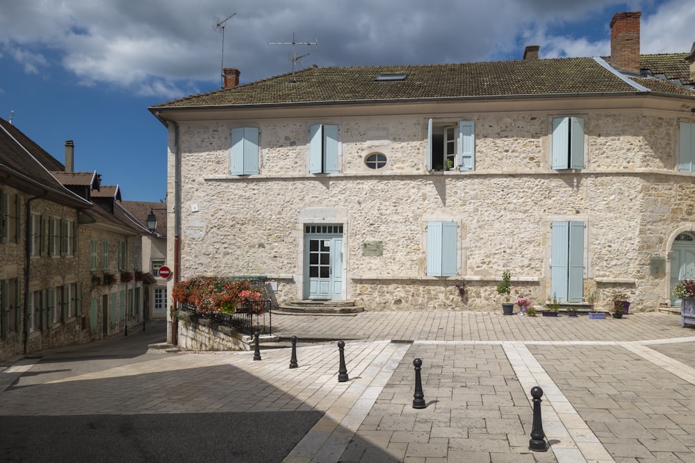 a stone building with blue shutters on the windows