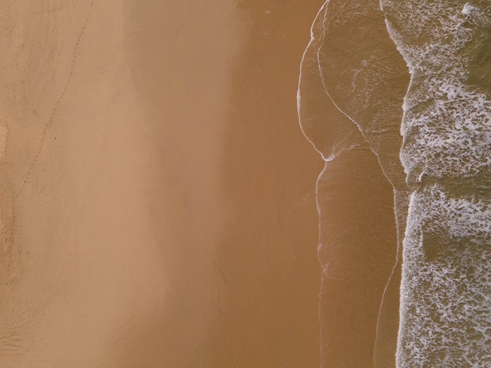 an aerial view of a sandy beach and ocean