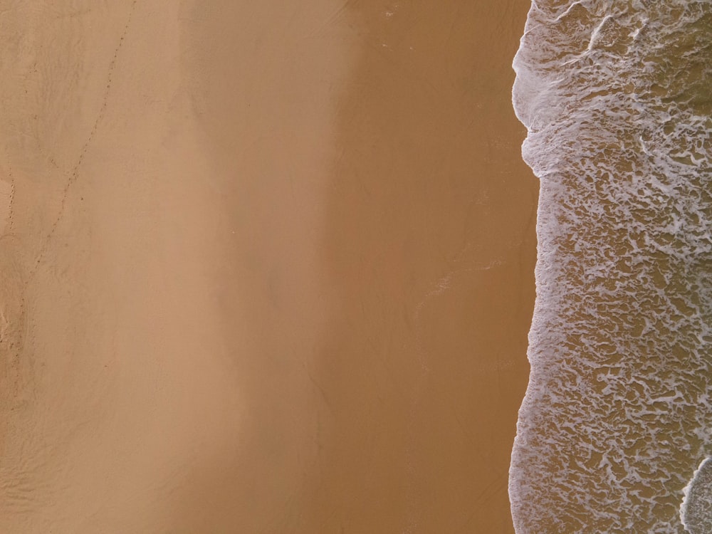 an aerial view of a sandy beach and ocean