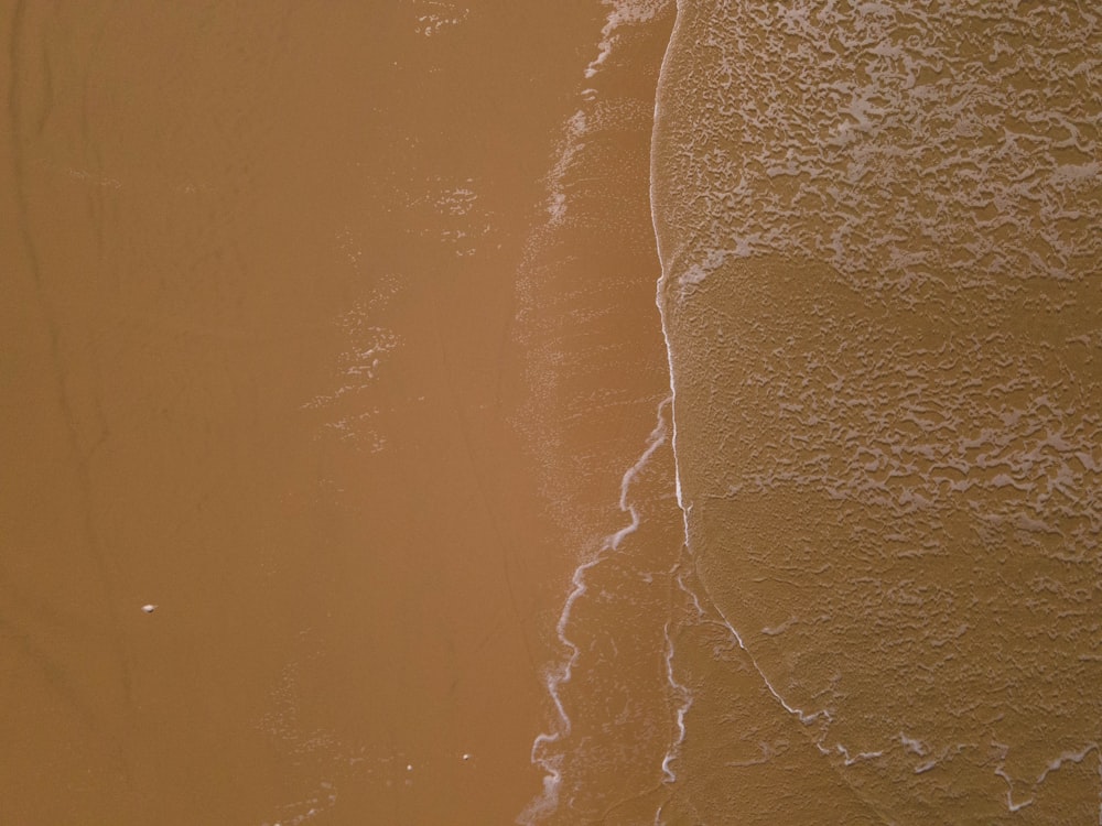 a person riding a surfboard on the beach