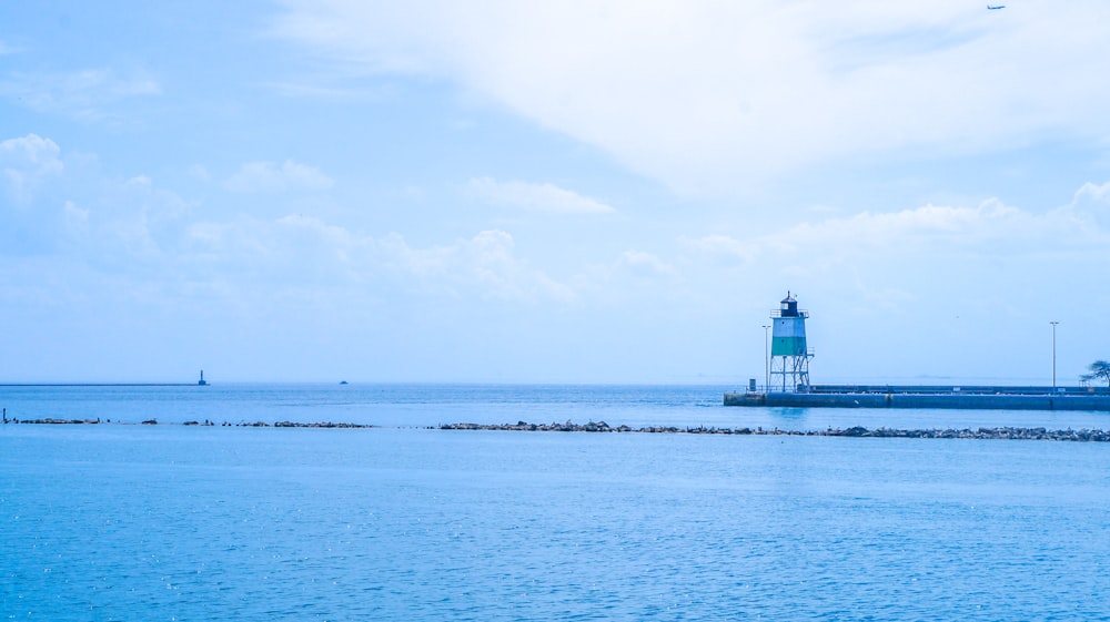 a light house in the middle of a body of water