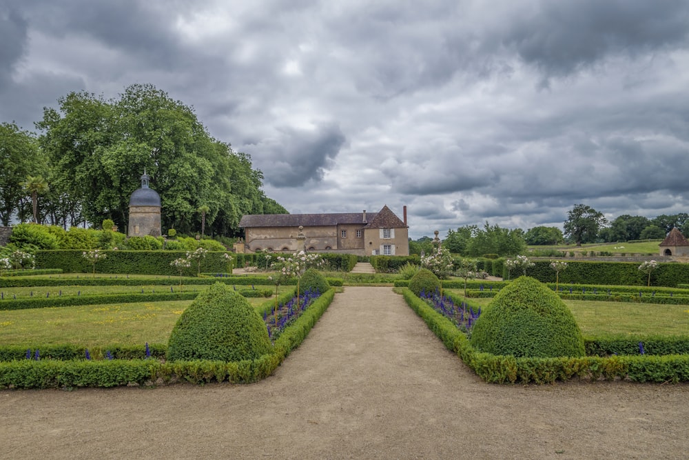 a large garden with a house in the background