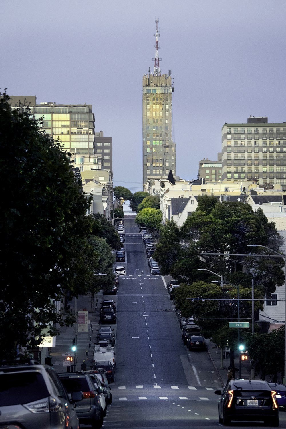 a view of a city street with a clock tower in the background