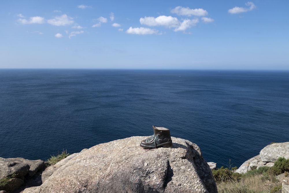 a pair of shoes sitting on top of a large rock