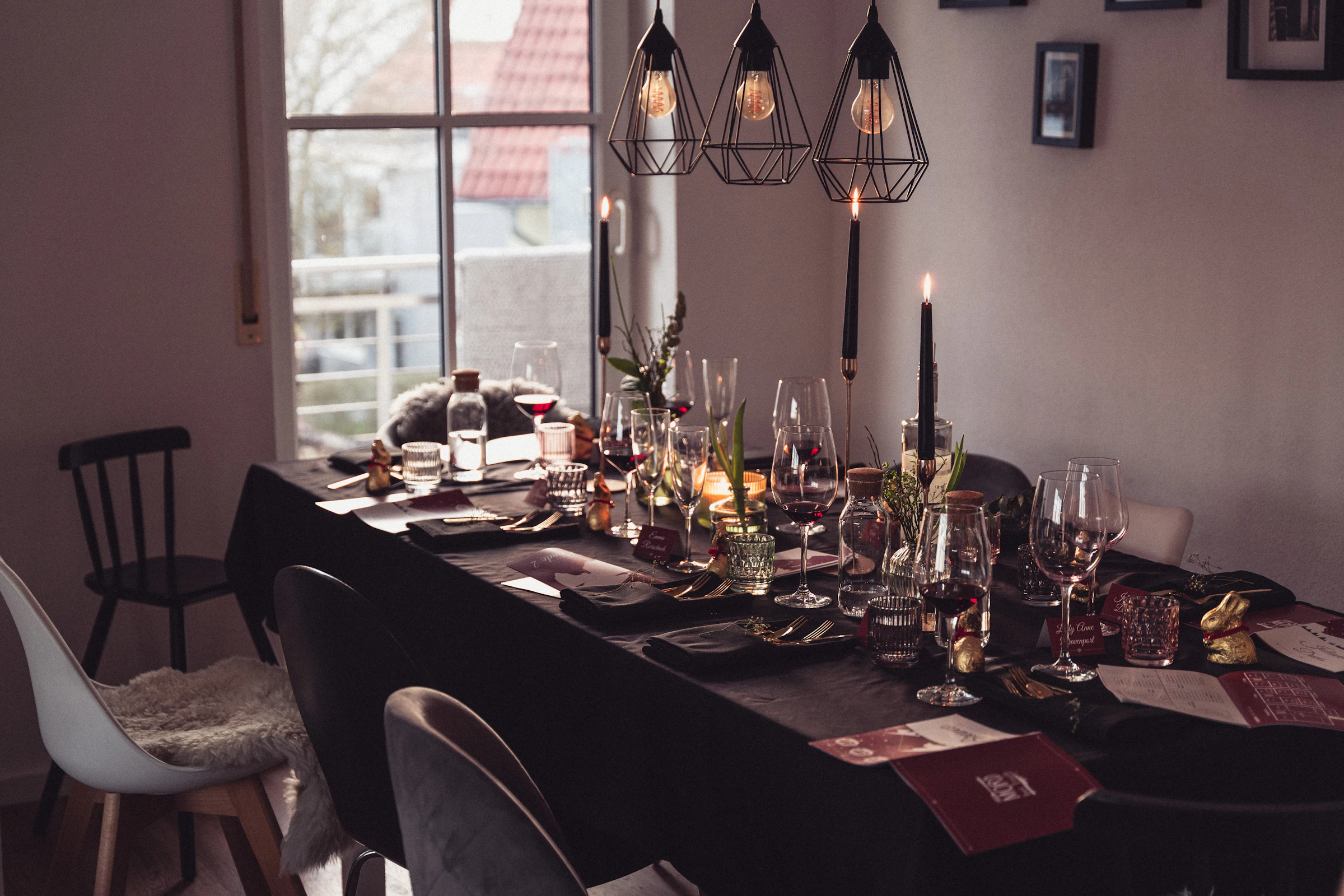 A private dining room with a long table set with wine glasses and candles