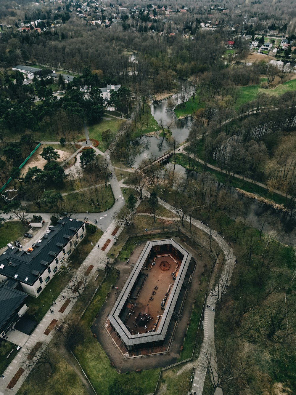 an aerial view of a building surrounded by trees