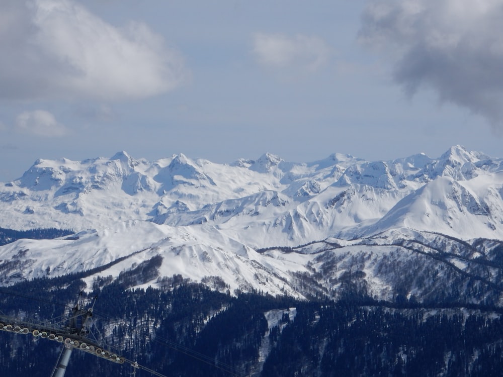 a view of a snowy mountain range from a ski lift