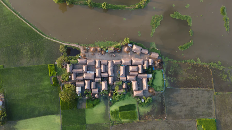 Floodwater standing across fields around a village, seen from the air.