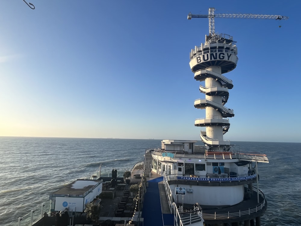 a very tall tower sitting on the side of a boat