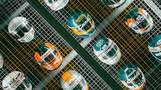 a group of different colored helmets on a metal grate