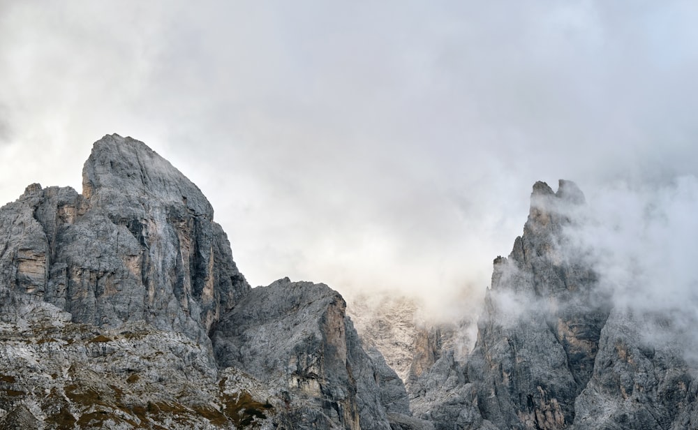 a mountain range covered in fog and clouds