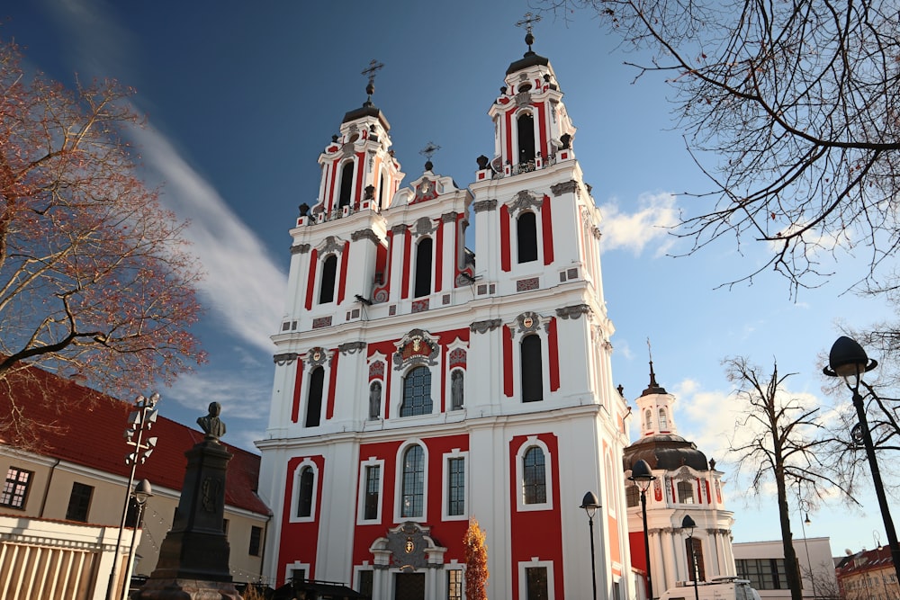 a large white and red building with two towers