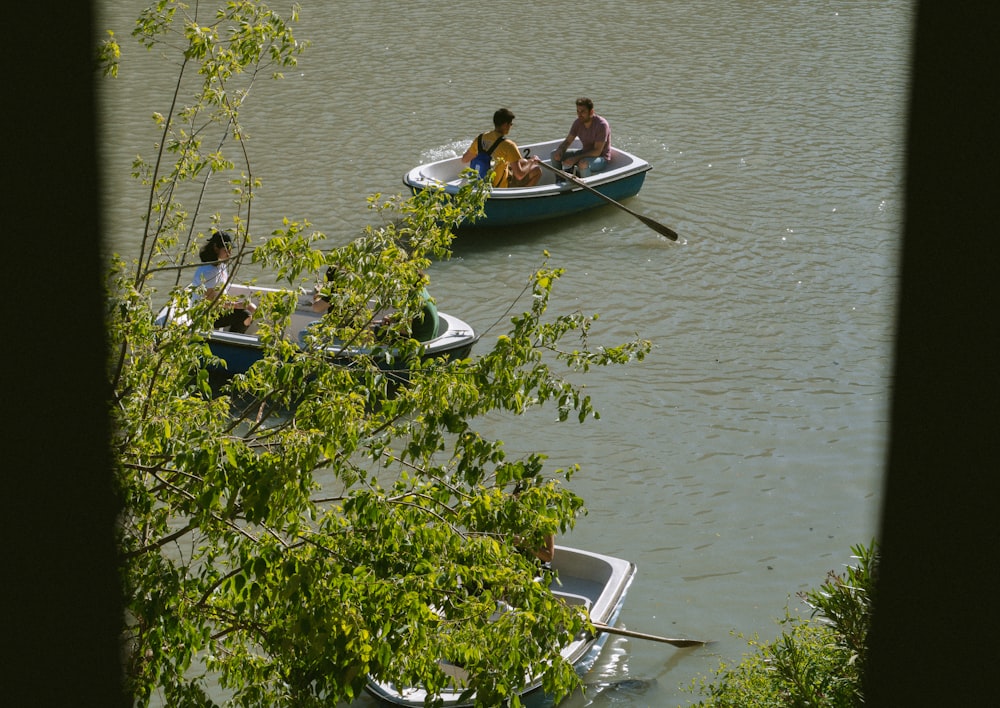 a group of people in a row boat on a lake