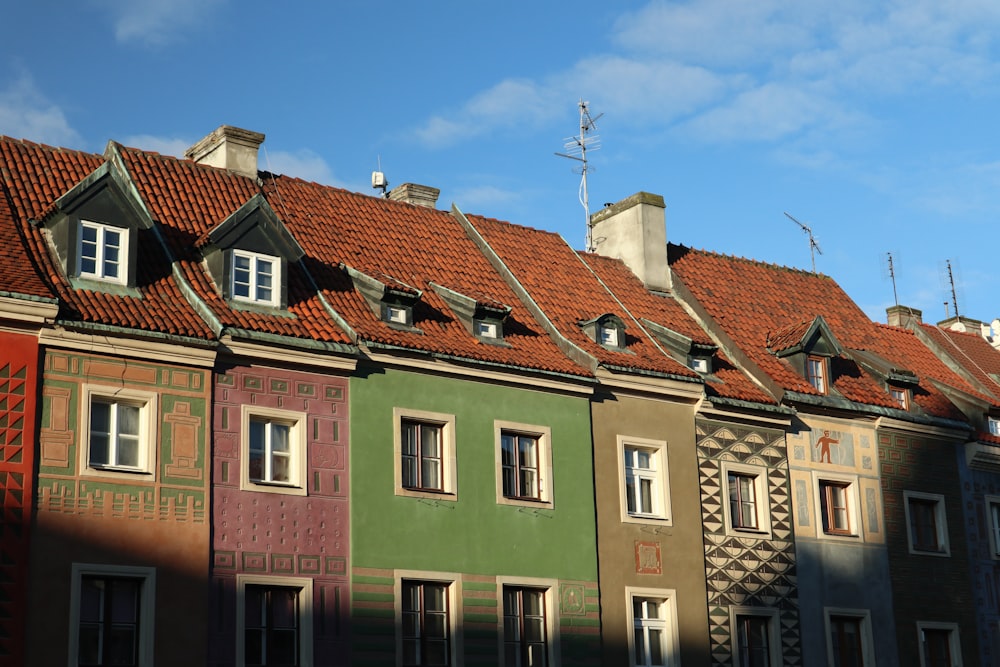 a row of multicolored buildings with a blue sky in the background