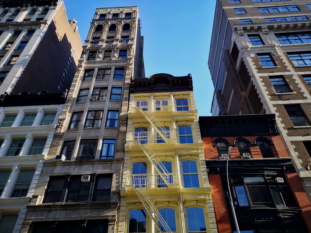 a group of tall buildings with windows and balconies