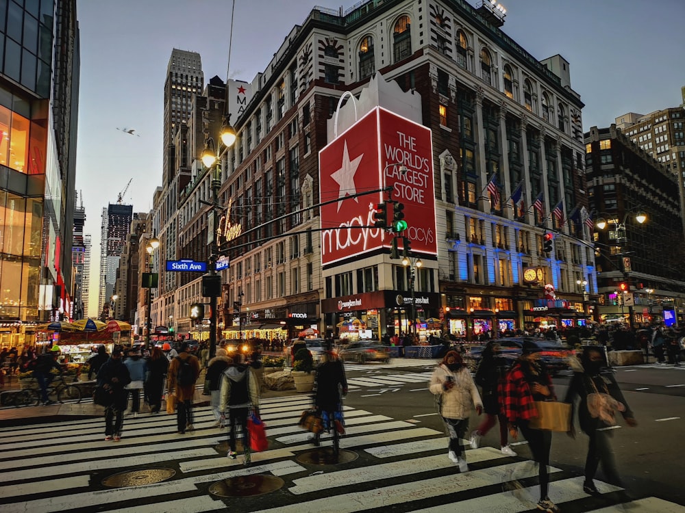 a group of people crossing a street at a crosswalk