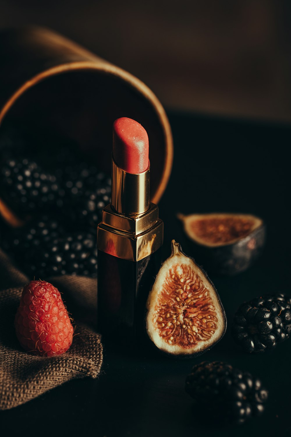 a lipstick and some fruit on a table