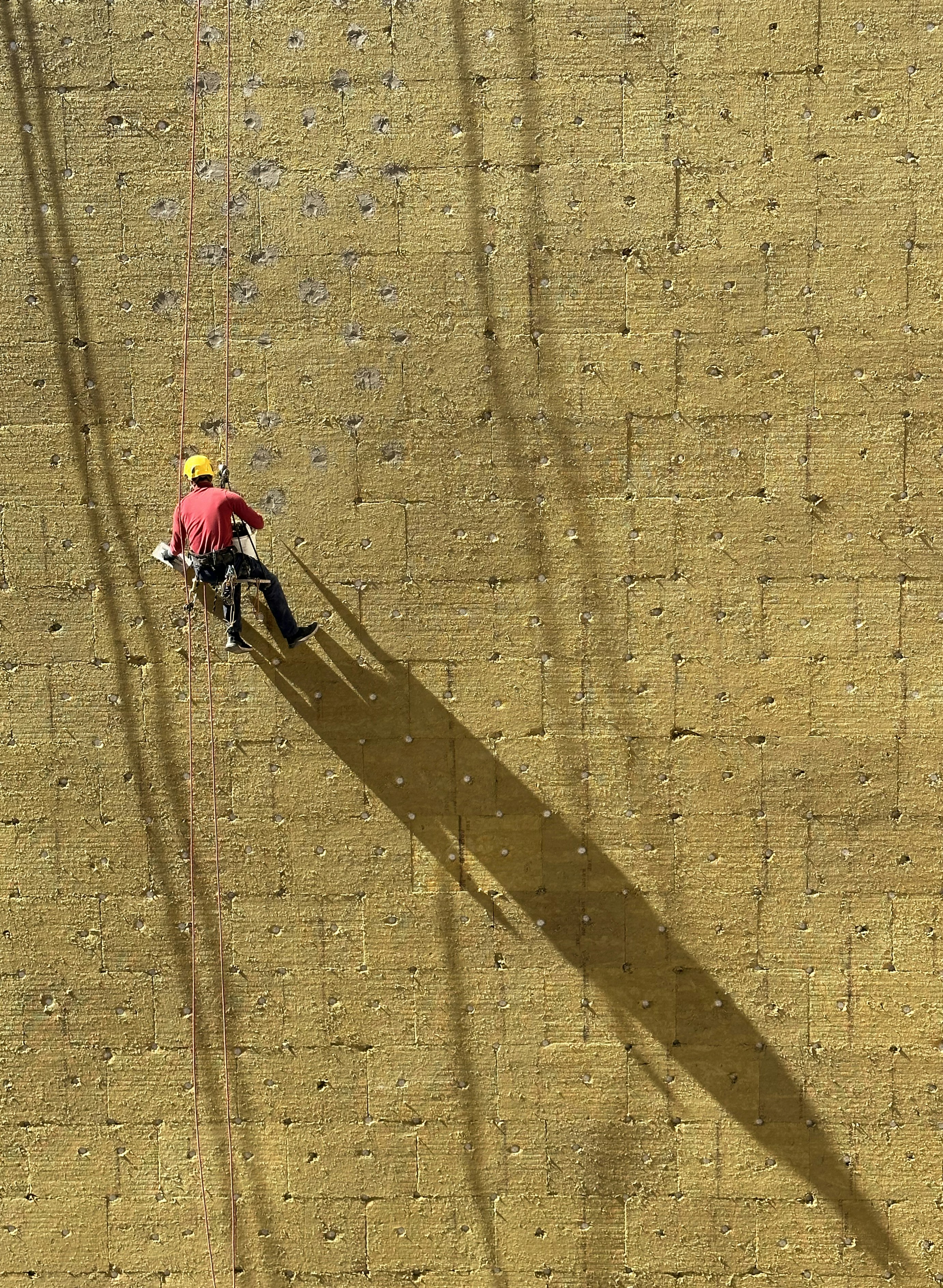 a man climbing up the side of a wall