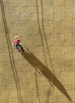a man climbing up the side of a wall