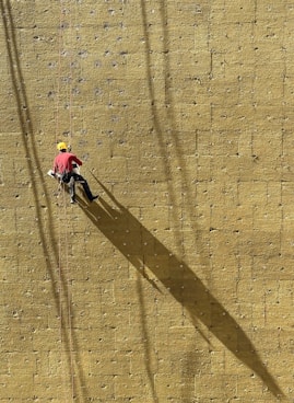 a man climbing up the side of a wall
