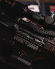 a close up of a rifle with a scope
