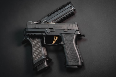 a close up of a gun on a black surface