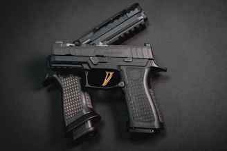 a close up of a gun on a black surface
