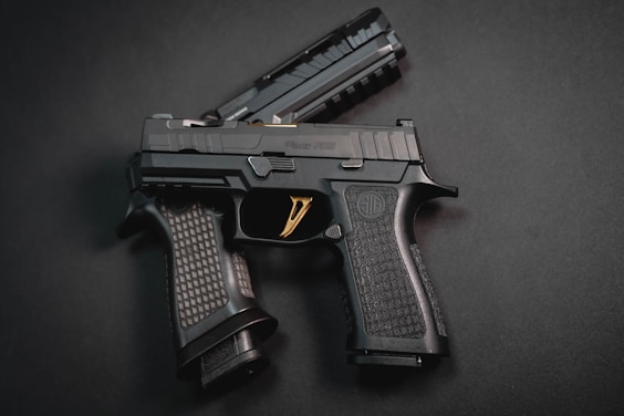 a close up of a gun on a black surface