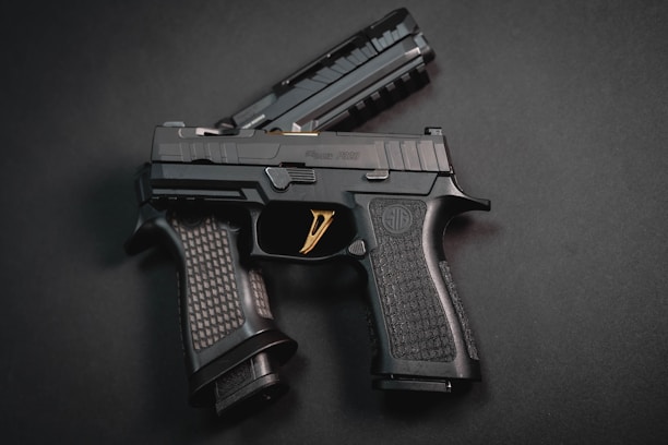 a close up of a gun on a black surface