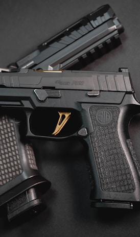 a close up of a gun on a black surface