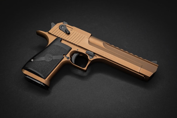 Side view of a Taurus firearm with a polished metal finish reflecting ambient light.