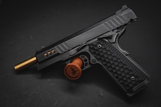 a close up of a gun on a black surface