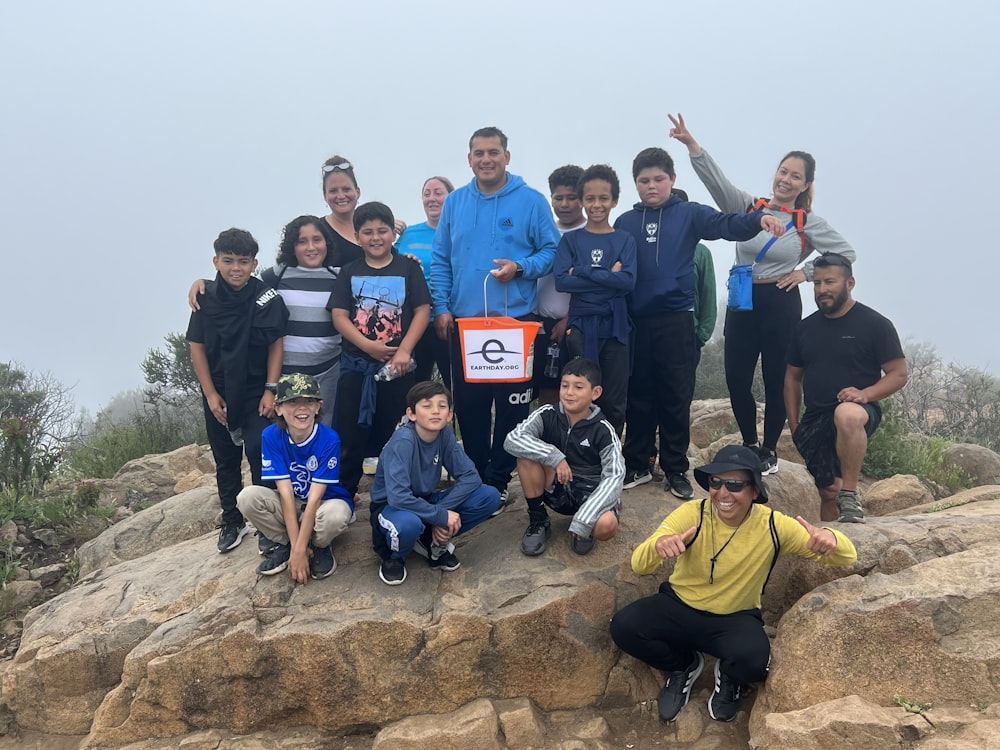 a group of people standing on top of a mountain