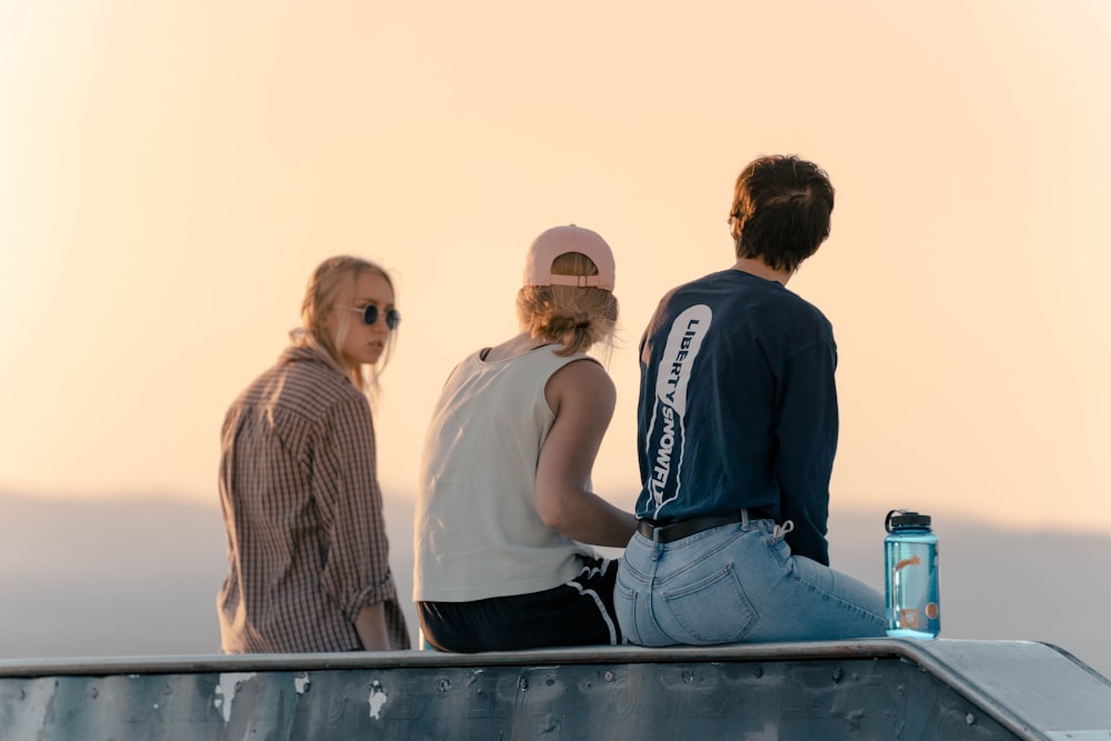 a group of people sitting on top of a ramp