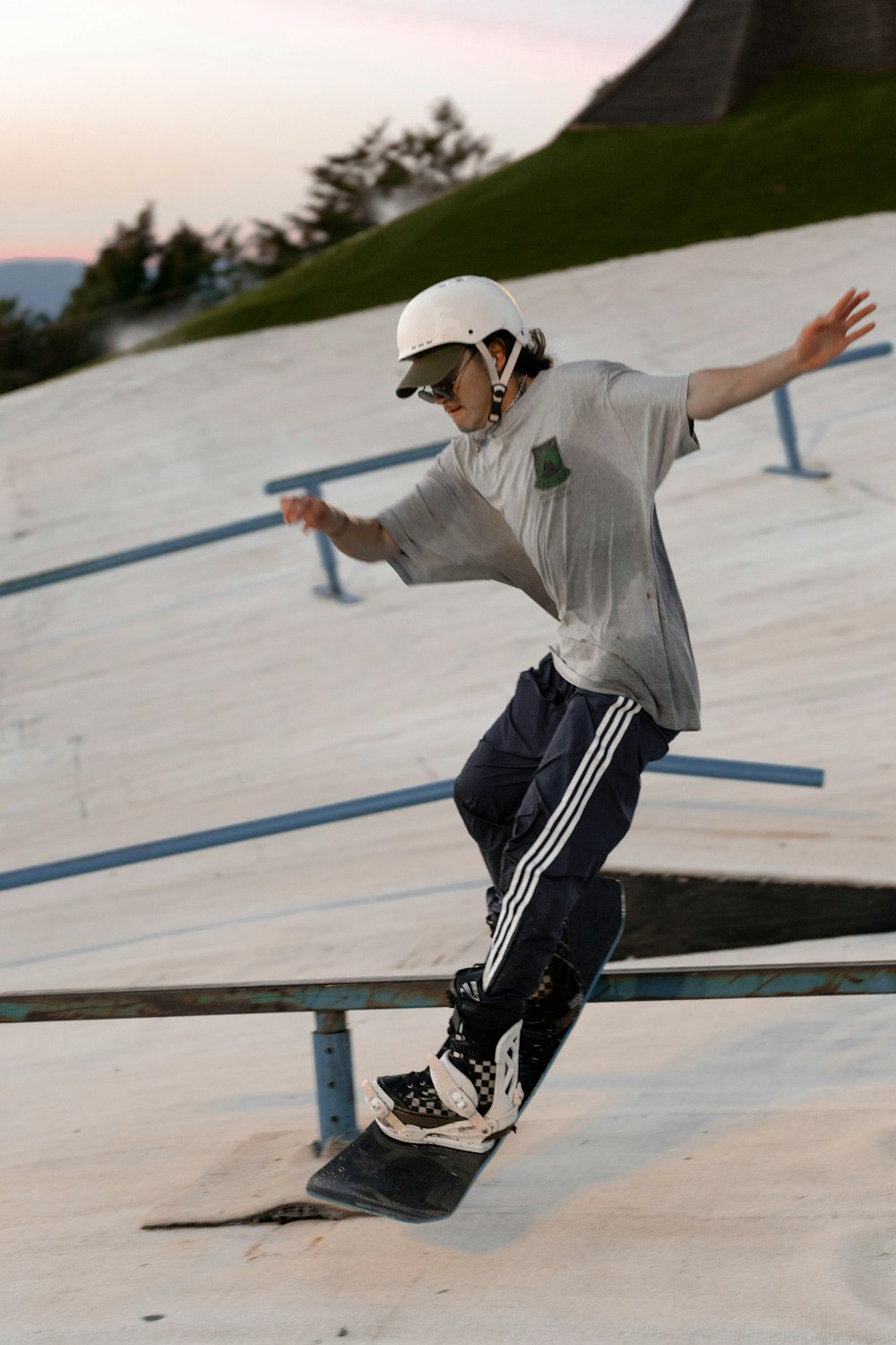 a man riding a skateboard down a metal rail