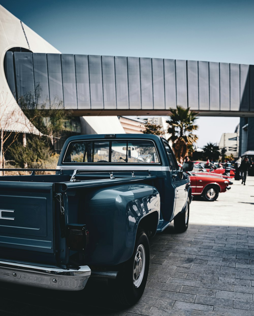 a blue truck parked in front of a building