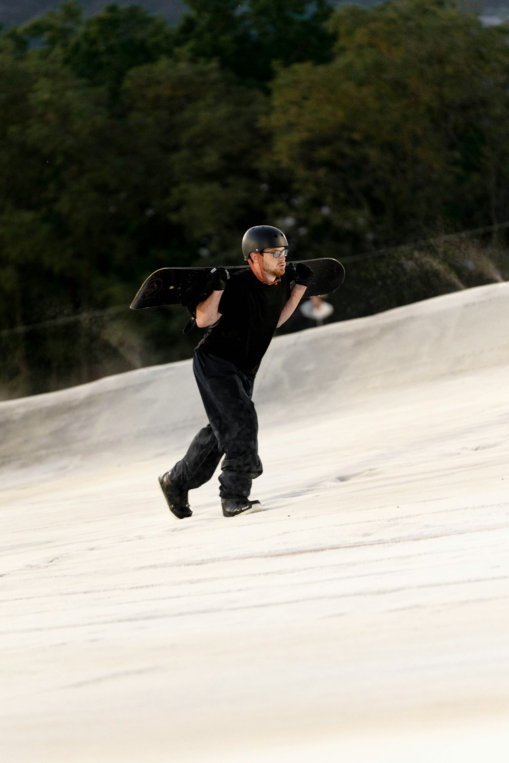 a man riding a snowboard down a snow covered slope