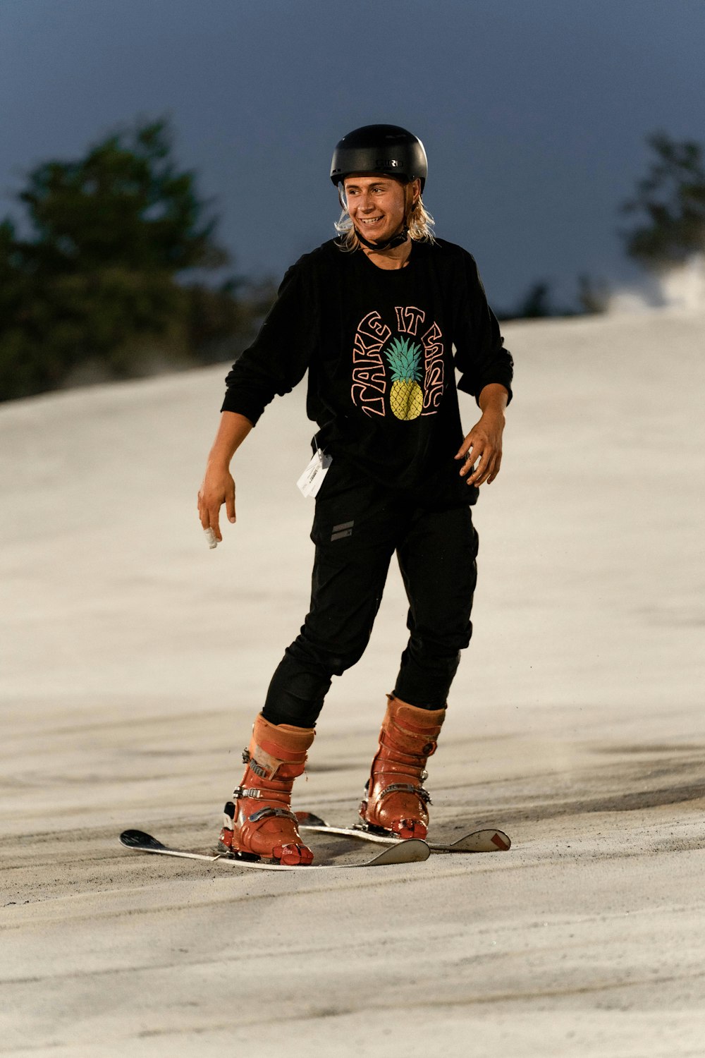 a man riding a snowboard down a snow covered slope