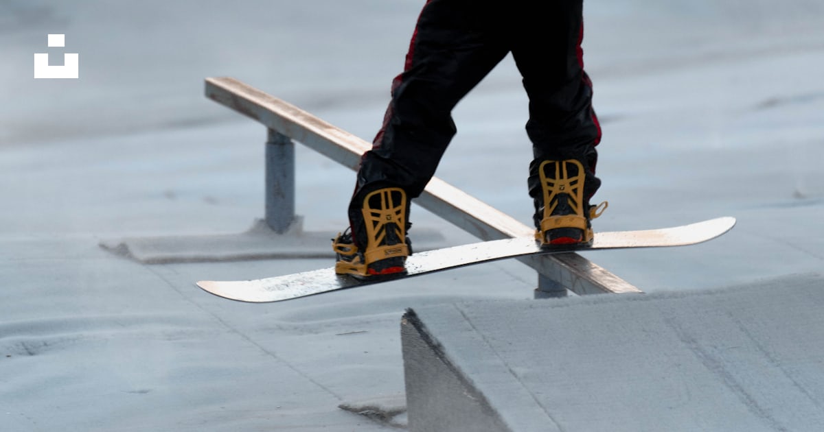 A man riding a snowboard on top of a ramp photo – Free Liberty mountain ...