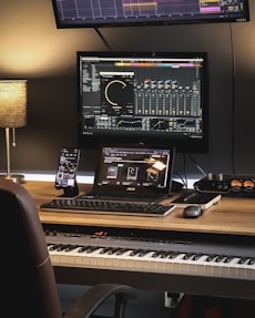 A warm, inviting workspace with musical instruments and a laptop ready for composing.