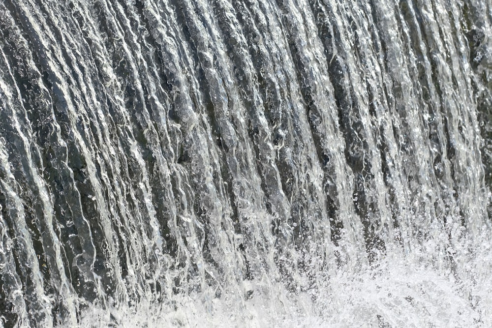 a close up of a waterfall with water coming out of it