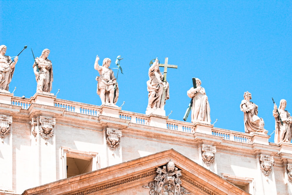 a group of statues on top of a building