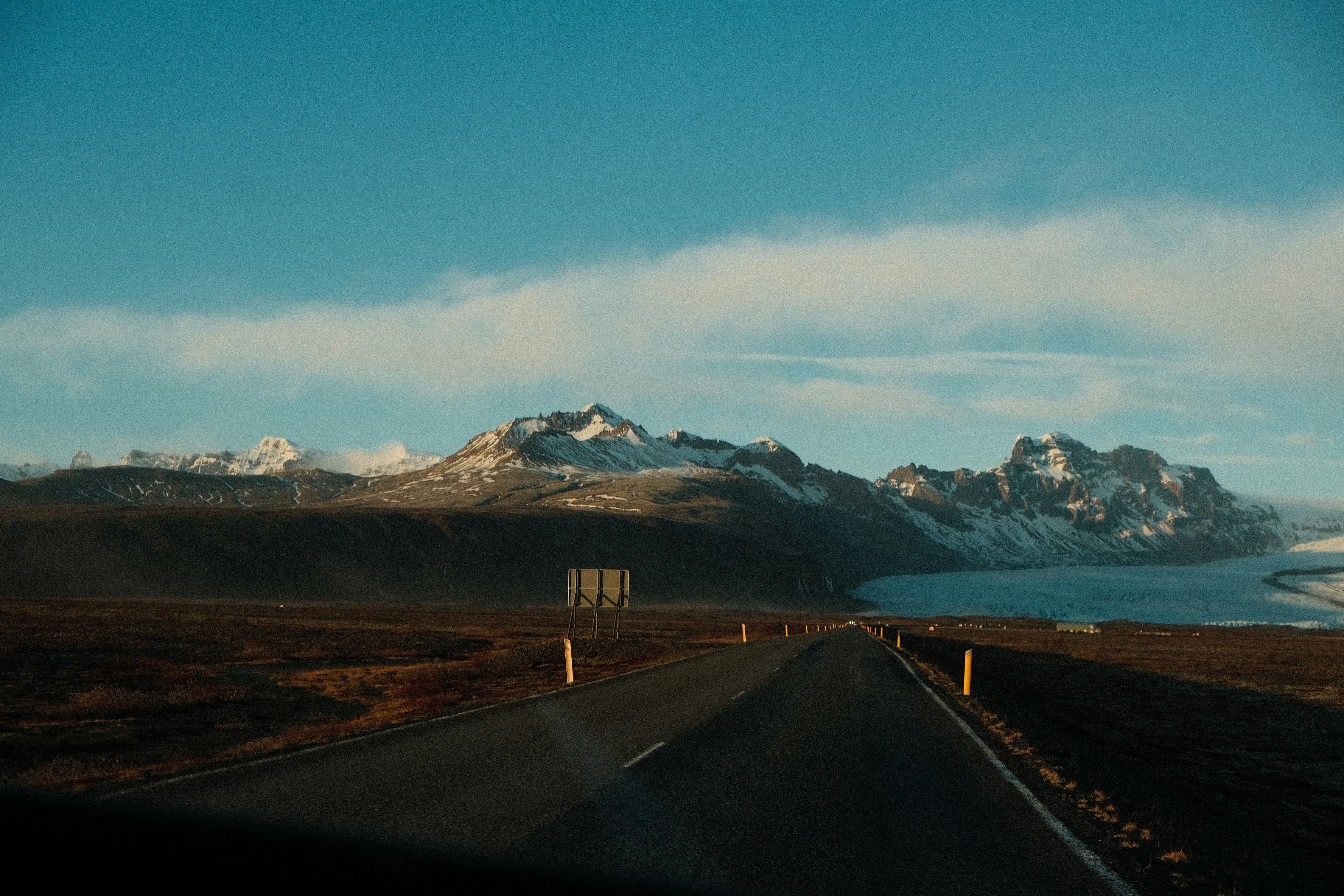 a view of a road with mountains in the background