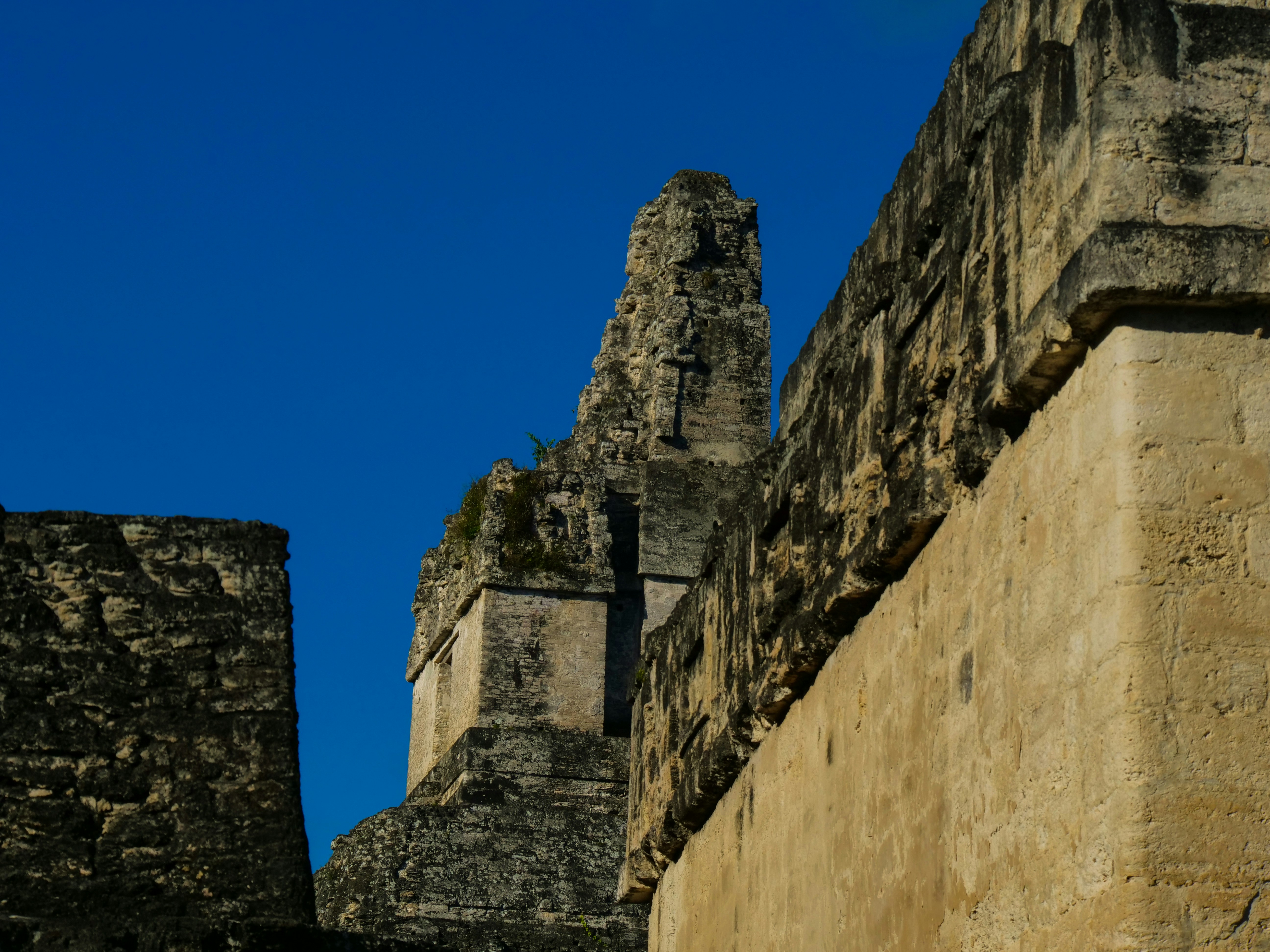 a stone building with a cross on the top of it, 