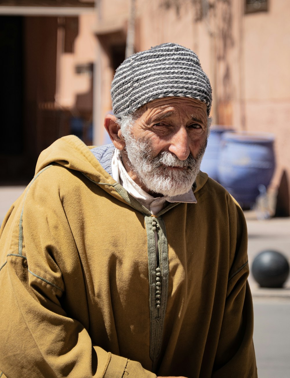 an old man with a beard and a striped hat