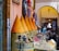 A group of travelers enjoying a vibrant Moroccan market filled with colorful spices and textiles.