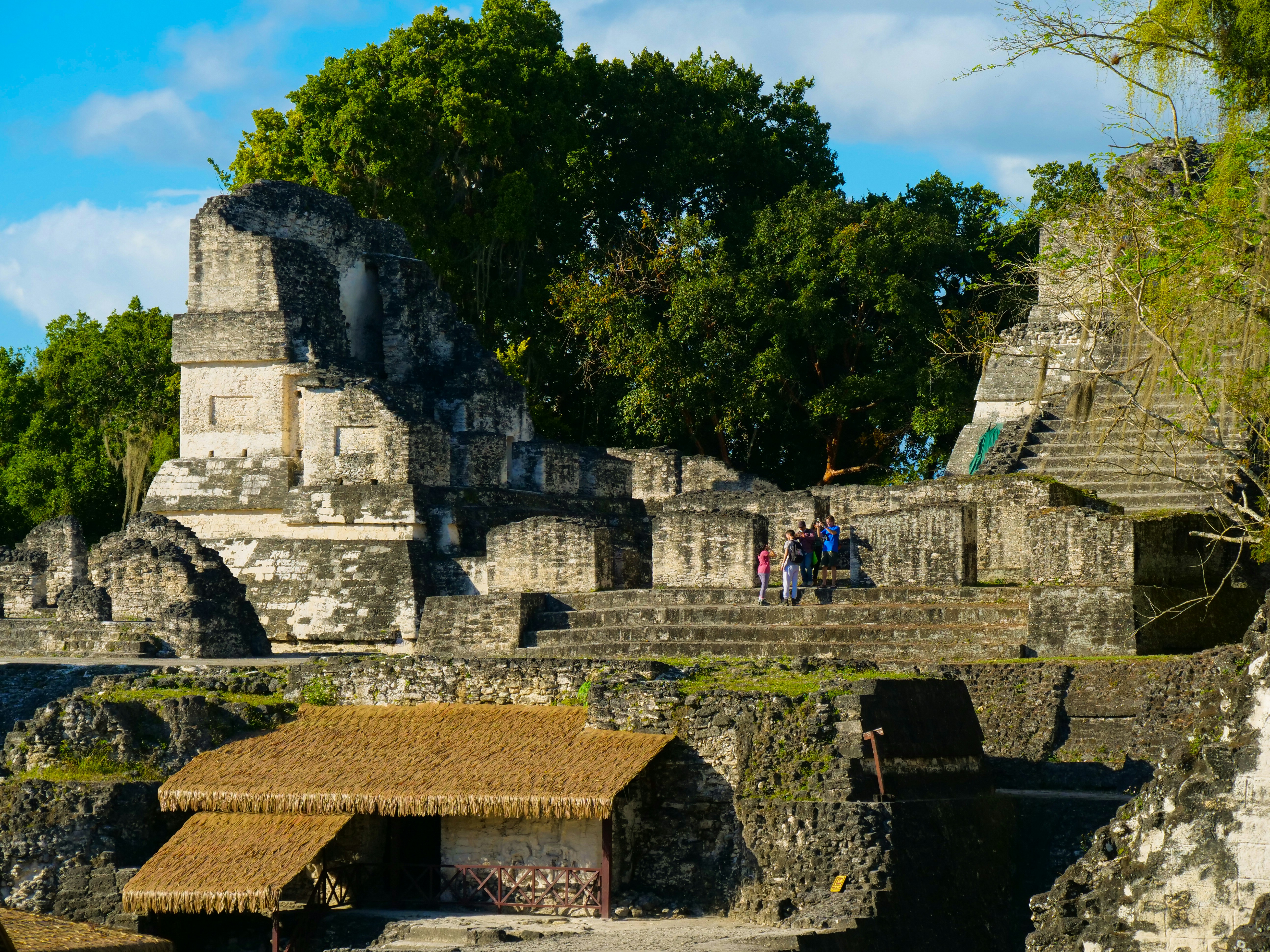a group of people standing on top of a stone structure, 