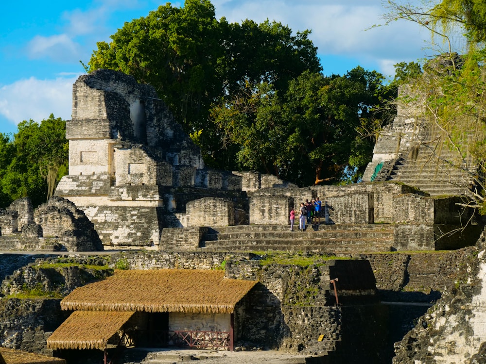 a group of people standing on top of a stone structure